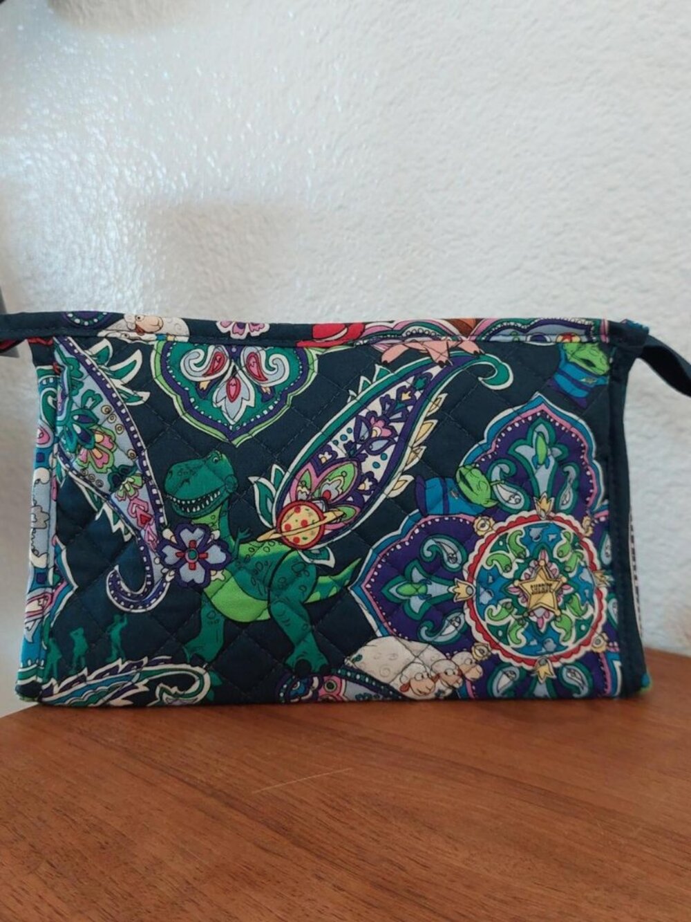 vera bradley Disney Pixar Toy Story quilted pouch with green dinosaur graphic an